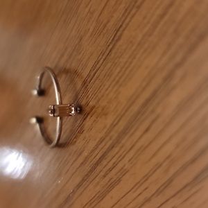 Gold plated ring with a pink center stone size 7